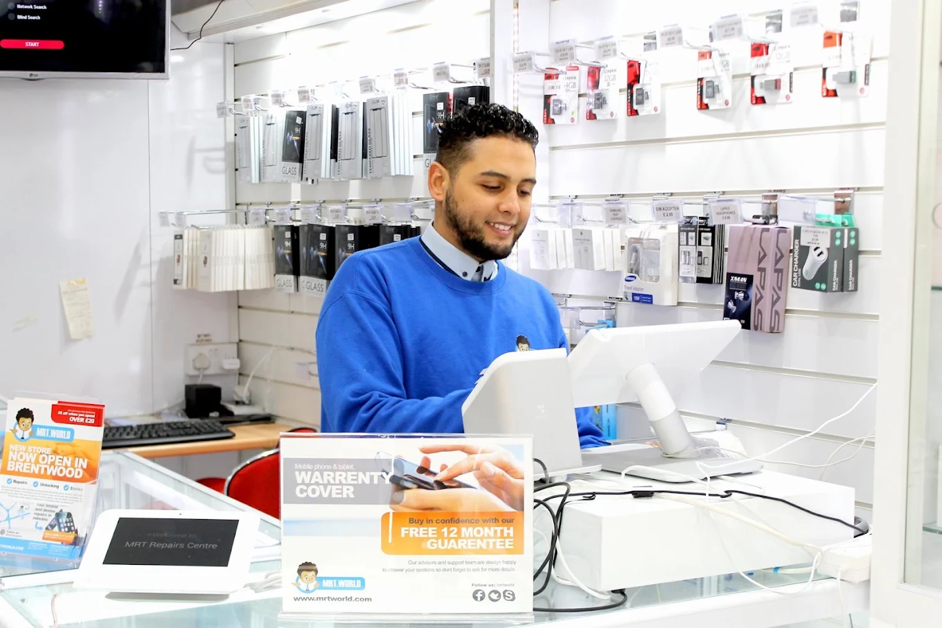 MRT World technician serving a customer at the counter